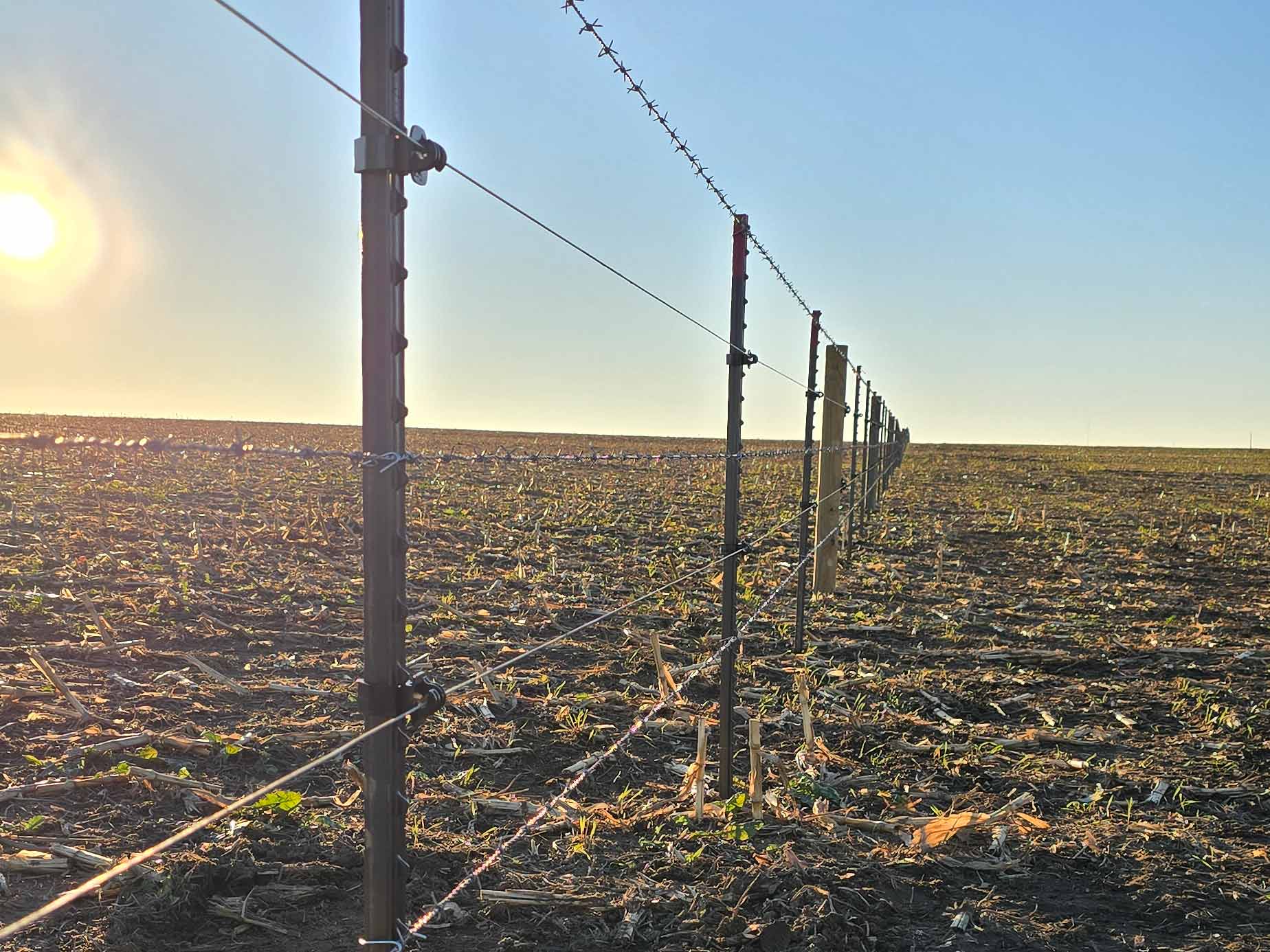Fence with Barbed wire fence installed around a farm property in Madison Wisconsin in Madison Wisconsin