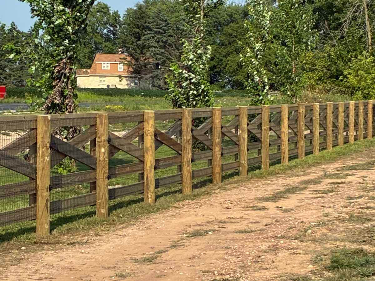 Fence with Crossbuck wood fence installed in Madison Wisconsin around a residential property in Madison Wisconsin