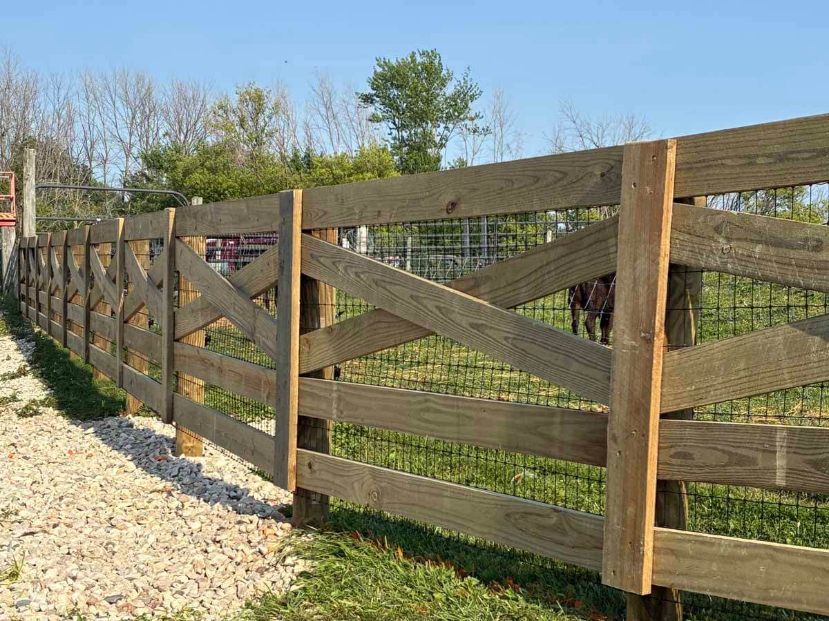Fence with Crossbuck farm fence installed around a farming property in Madison Wisconsin in Madison Wisconsin