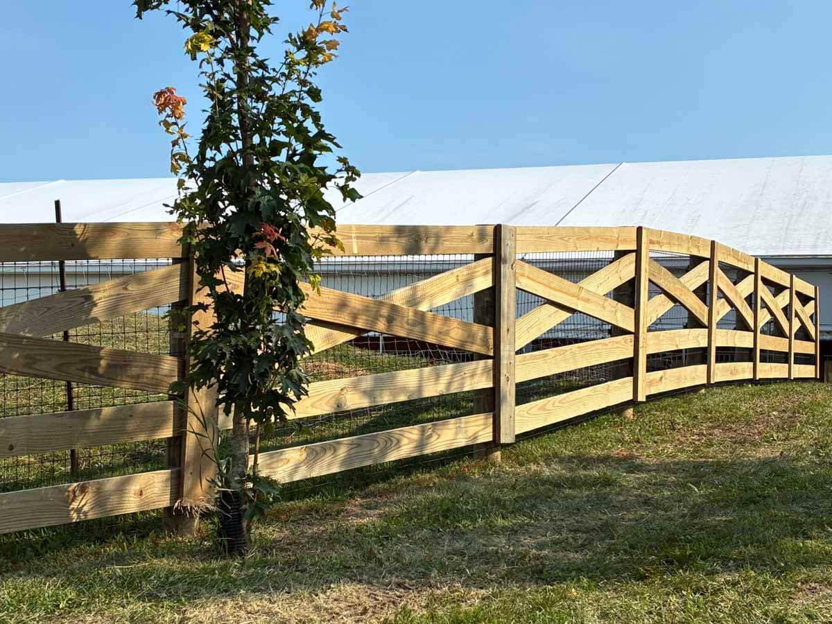 Fence with Crossbuck wood fence installed around a farm property in Madison Wisconsin in Madison Wisconsin
